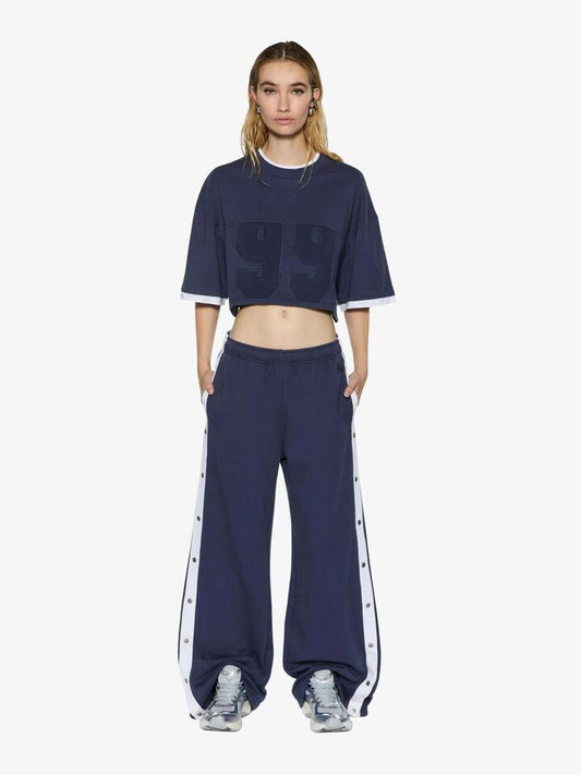 Image of a model wearing Pants. Productname: Ksubi Origin Trakpants Spliced Ink in DARK BLUE colour by brand - Ksubi