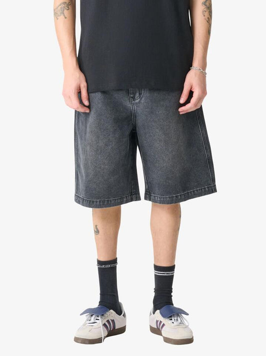 Image of a model wearing Denim. Productname: Xlarge Baggy Bull Denim 91 Shorts in Faded Black colour by brand - Xlarge