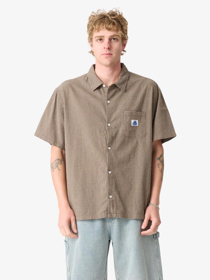 Image of a model wearing Tops. Productname: Xlarge Liam Ss Shirt in Brown colour by brand - Xlarge
