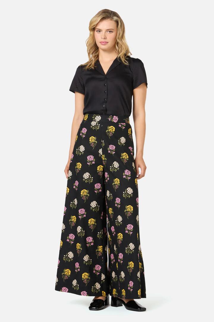Image of a model wearing Pants. Productname: Astrid Rose Wide Leg Pant in Black colour by brand - Princess Highway