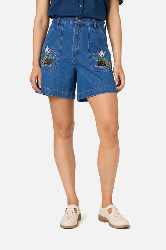 Image of a model wearing Denim. Productname: Swan Embroidered Denim Short in Blue Denim colour by brand - Princess Highway