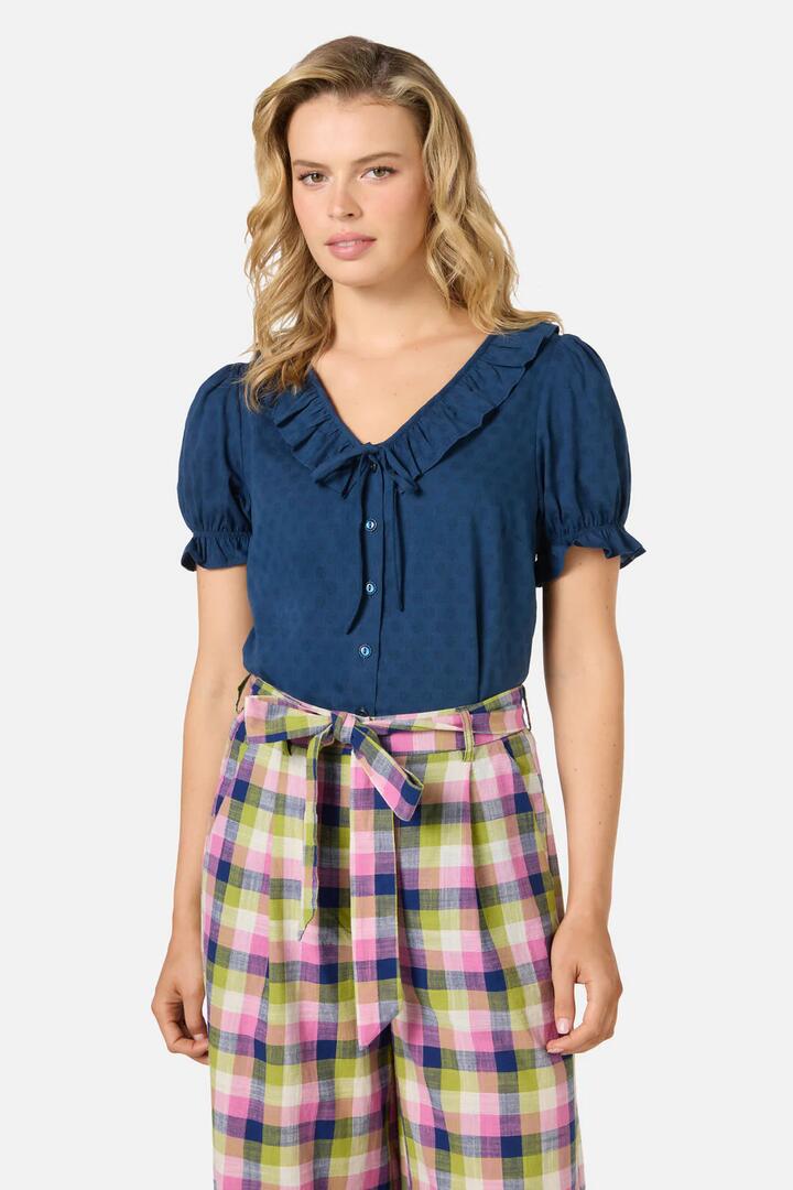 Image of a model wearing Tops. Productname: Lulu Ruffle Blouse in Navy colour by brand - Princess Highway