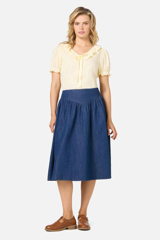 Image of a model wearing Denim. Productname: Nellie Yoke Denim Skirt in Blue Denim colour by brand - Princess Highway
