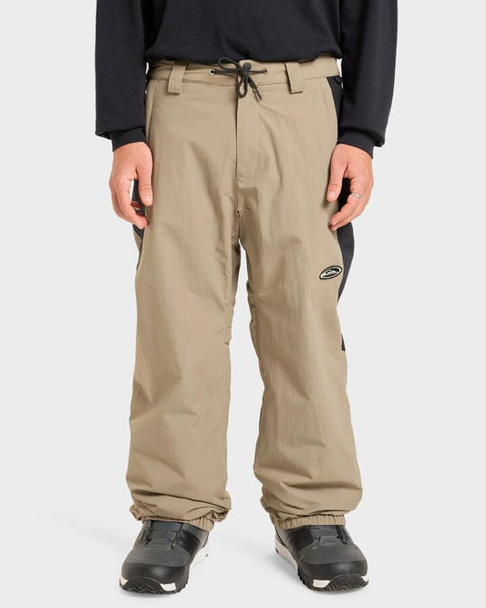 Image of a model wearing Pants. Productname: Quiksilver - Mens Snow Down Snow Pants - Fallen Rock - in Fallen Rock colour by brand - Quiksilver