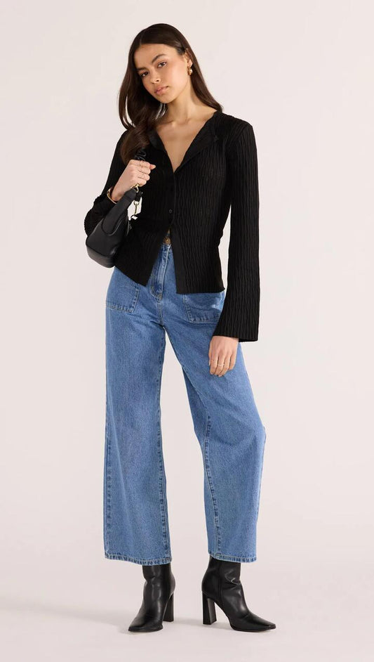 Image of a model wearing Outerwear. Product name - Johnna Button Knit Top Black in Black colour by brand - MINKPINK