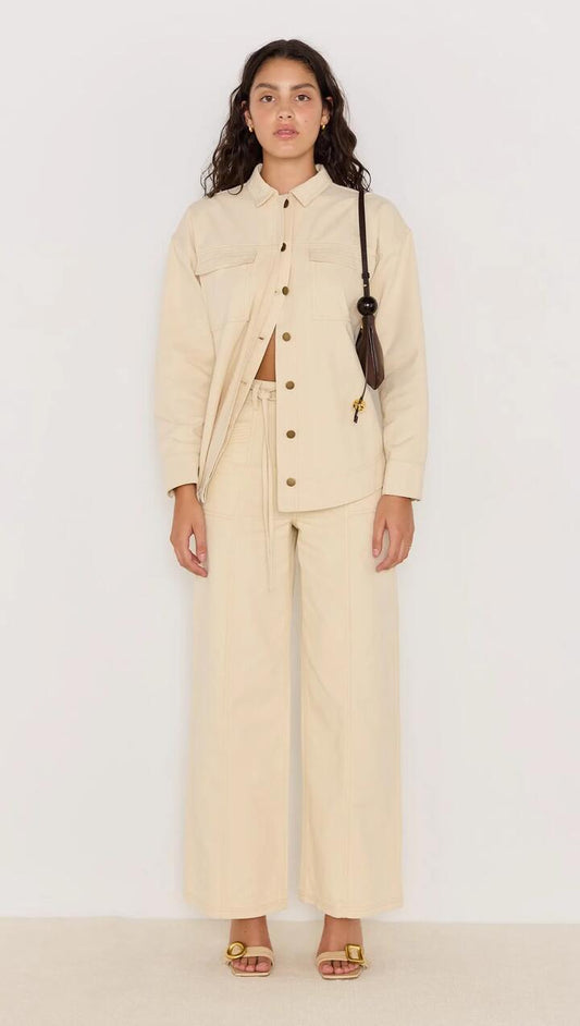 Image of a model wearing Pants. Product name - Jane Drill Straight Leg Pant in Ivory colour by brand - MINKPINK