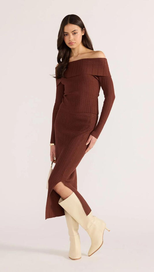Image of a model wearing Skirts. Product name - Zoe Knit Midi Tube Skirt in Choc colour by brand - MINKPINK