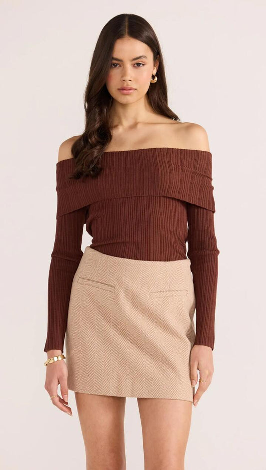 Image of a model wearing Tops. Product name - Zoe Off Shoulder Knit Top in Choc colour by brand - MINKPINK