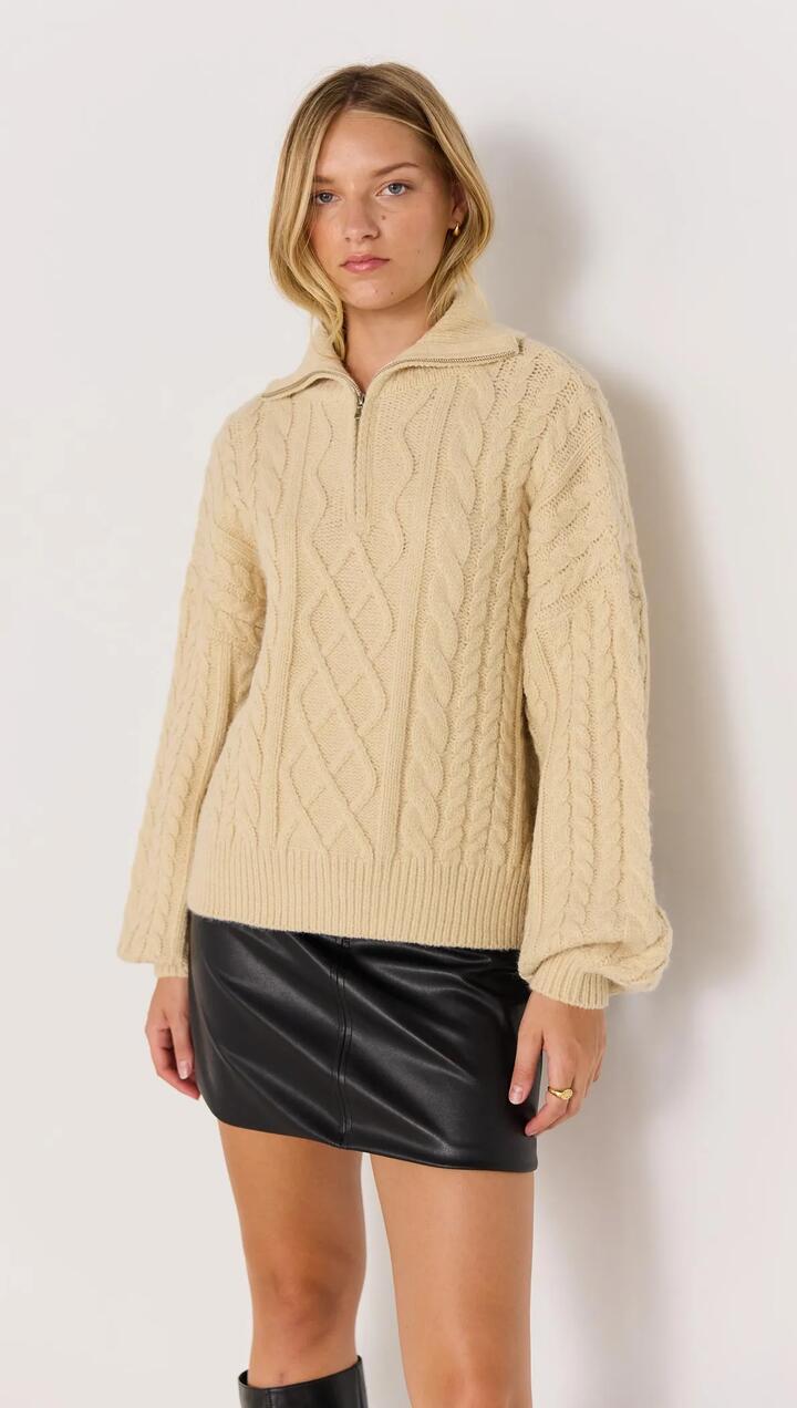 Image of a model wearing Outerwear. Product name - Varsity Cable Knit Sweater in Oat colour by brand - MINKPINK