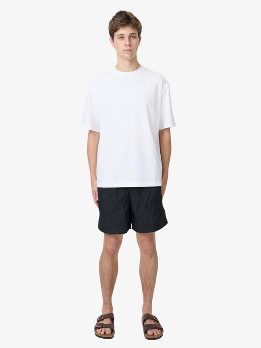 Image of a model wearing Shorts. Productname: Article One Bryn Swim Trunks in Black colour by brand - Article One