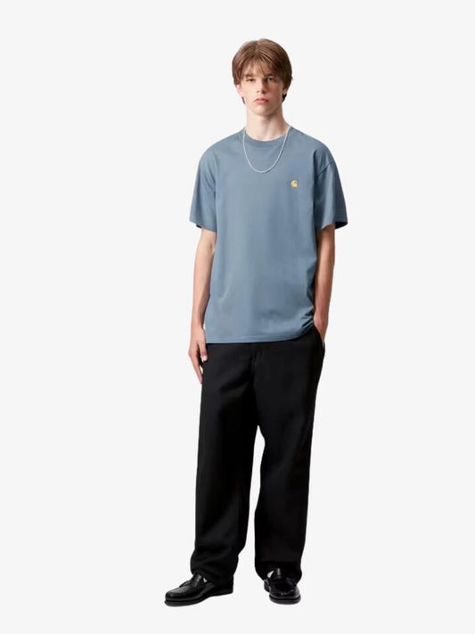 Image of a model wearing Tops. Productname: Carhartt Wip Short Sleeve Chase T-Shirt in Angelite/Gold colour by brand - Carhartt Wip