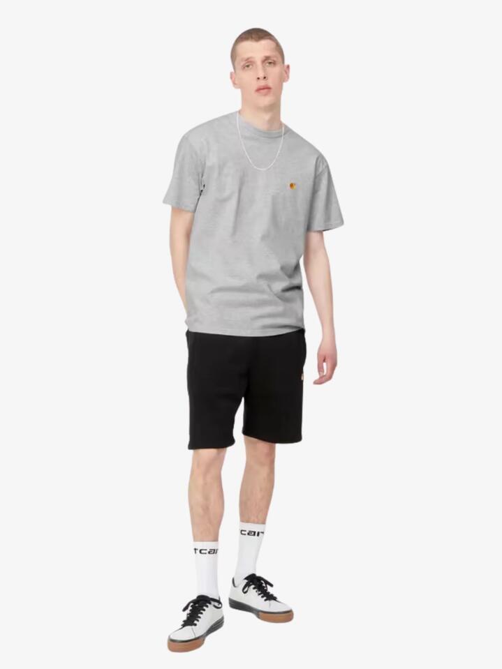 Image of a model wearing Tops. Productname: Carhartt Wip Short Sleeve Chase T-Shirt in Ash Heather Gold colour by brand - Carhartt Wip