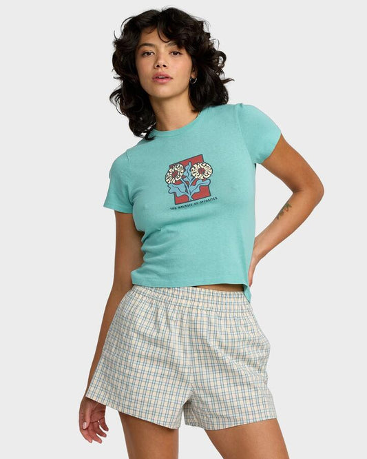 Image of a model wearing Tops. Productname: RVCA Womens 411 T-Shirt Sky Blue - in Sky Blue colour by brand - RVCA