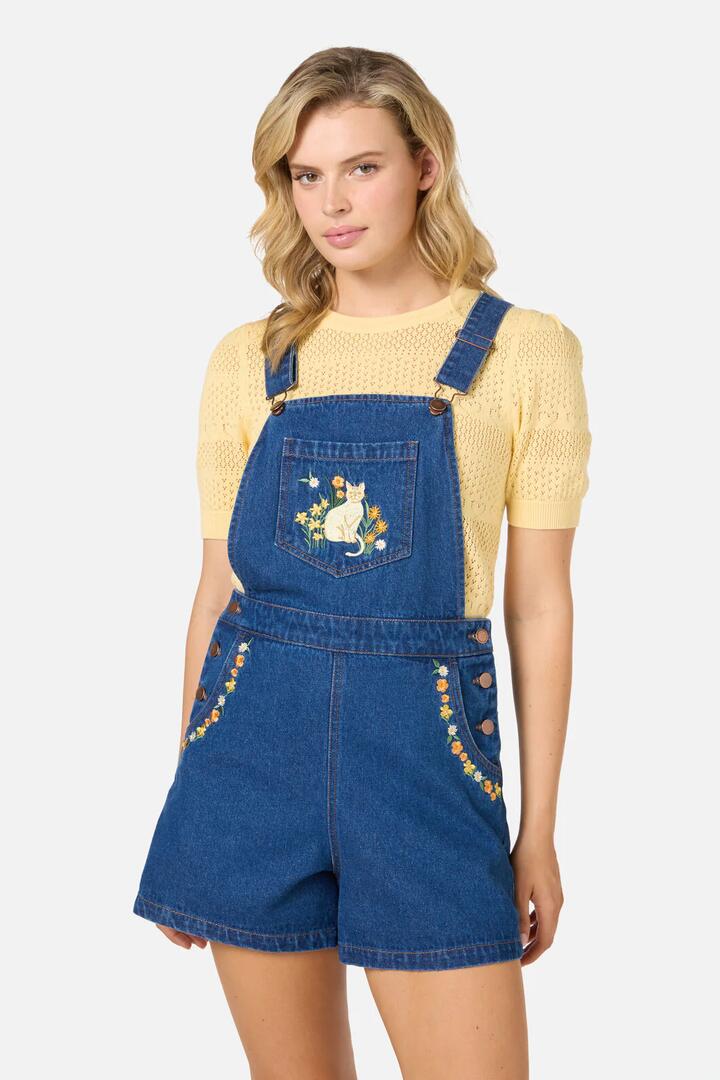 Image of a model wearing Pants. Productname: Cats Embroidered Short Overall in Blue Denim colour by brand - Princess Highway
