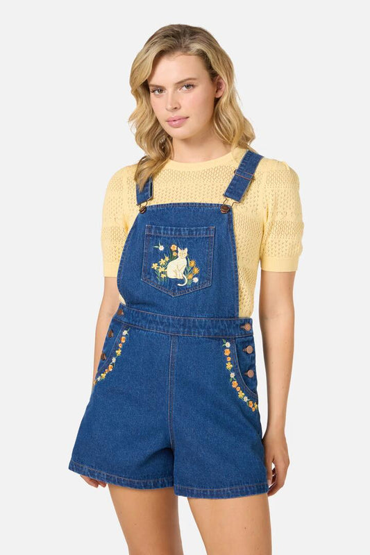 Image of a model wearing Pants. Productname: Cats Embroidered Short Overall in Blue Denim colour by brand - Princess Highway