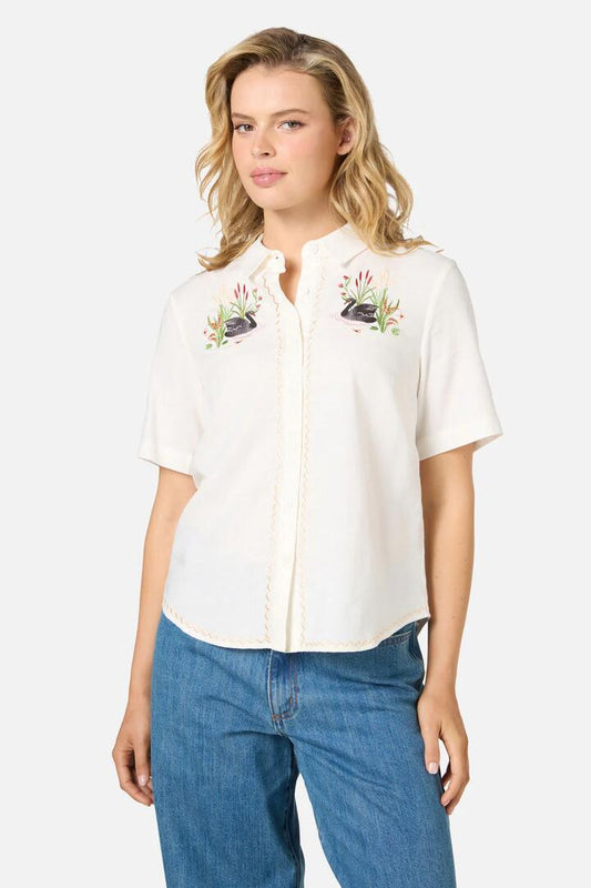 Image of a model wearing Tops. Productname: Swan Embroidered Shirt in Cream colour by brand - Princess Highway