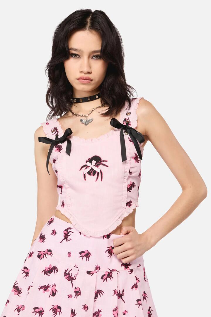 Image of a model wearing Tops. Product name - Rococo Life Spiider Bow Print in Pink colour by brand - Dangerfield