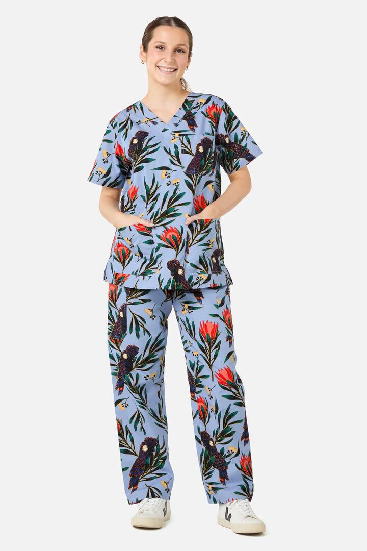 Image of a model wearing Uniforms & Workwear. Productname: Cockatoo & Protea Scrub Set in Blue colour by brand - Scrubs With Love