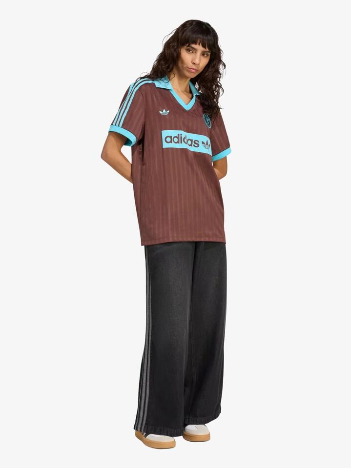 Image of a model wearing Tops. Productname: Adidas Graphic Soccer-Inspired Jersey in Auburn colour by brand - Adidas