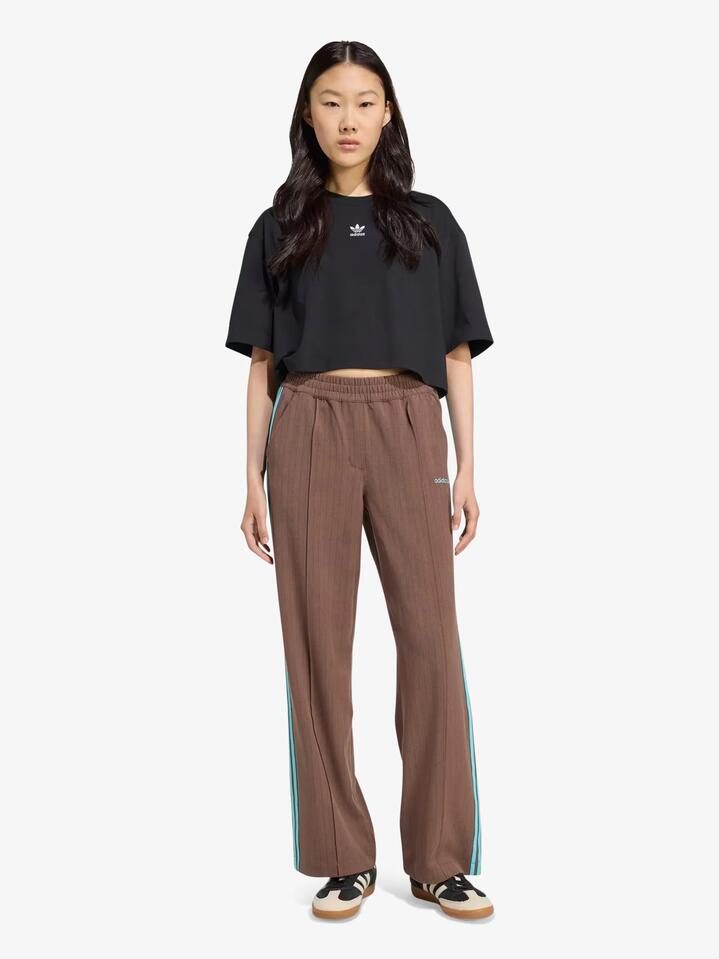 Image of a model wearing Pants. Productname: Adidas Tailored Pants in auburn colour by brand - Adidas