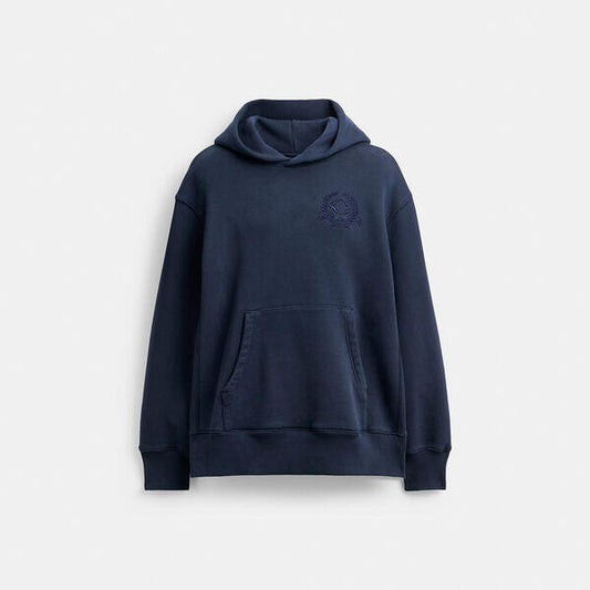 Image of a model wearing Outerwear. Productname: Oversized Signature Crest Hoodie In Organic Cotton in NAVY BLUE colour by brand - Coach Outlet Australia