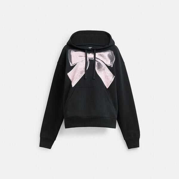 Image of a model wearing Outerwear. Productname: Bow Hoodie in BLACK colour by brand - Coach Outlet Australia