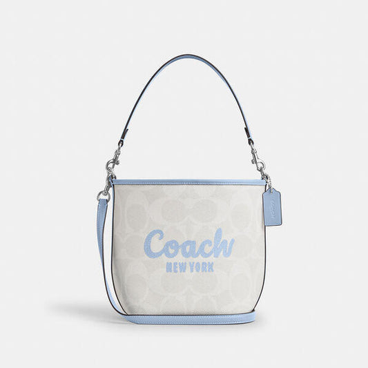 Image of Bags. Productname: City Bucket Bag With Coach Graphic in CHALK/BLUEBELL colour by brand - Coach Outlet Australia
