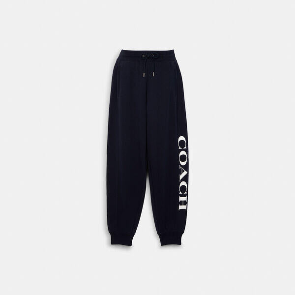 Image of a model wearing Pants. Productname: Essential Joggers in NAVY colour by brand - Coach Outlet Australia