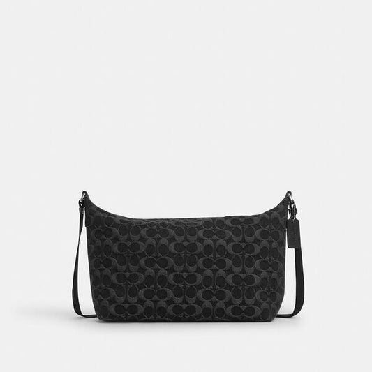 Image of a model wearing Denim. Productname: Finn Crossbody Bag In Signature Denim in BLACK colour by brand - Coach Outlet Australia