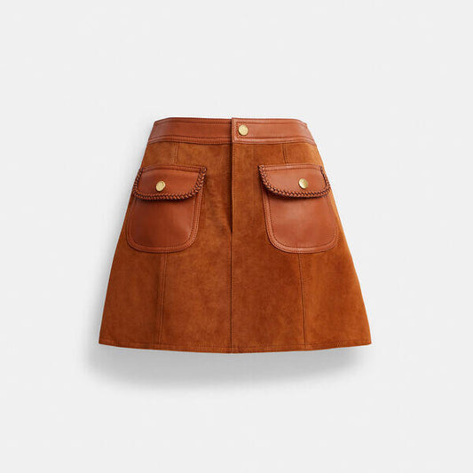 Image of a model wearing Skirts. Productname: Braided Suede Mini Skirt in Burnished Amber colour by brand - Coach Outlet Australia