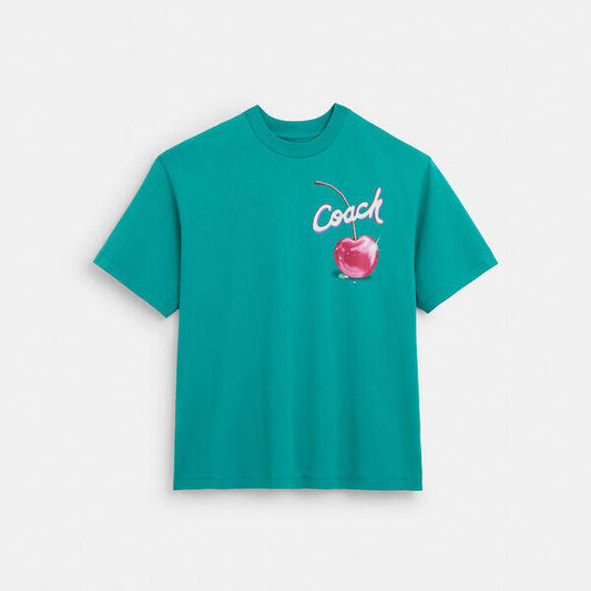 Image of a model wearing Tops. Productname: Cherry Print T-Shirt In Organic Cotton in DARK TEAL colour by brand - Coach Outlet Australia