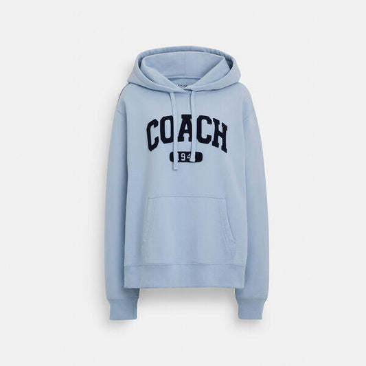 Image of a model wearing Outerwear. Productname: Sporty Signature Hoodie in LIGHT BLUE colour by brand - Coach Outlet Australia