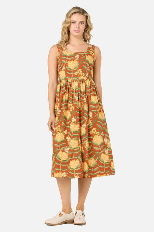 Image of a model wearing Dress. Productname: Protea Flower Midi Dress in Rust colour by brand - Princess Highway
