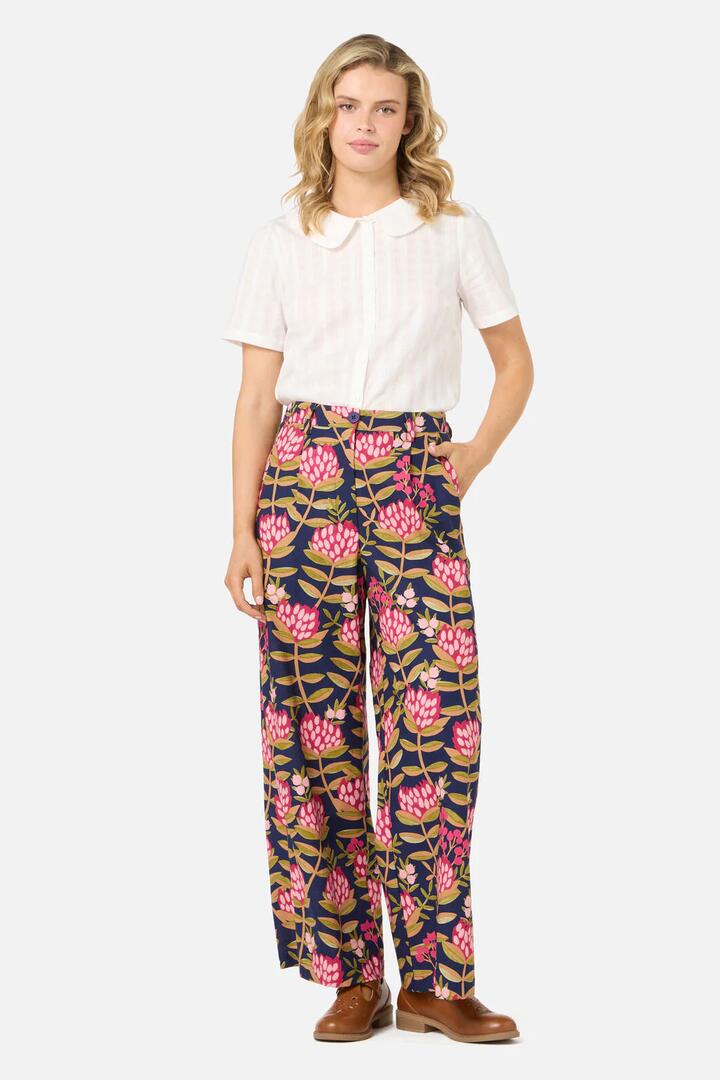 Image of a model wearing Pants. Productname: Protea Flower Relaxed Pant in Navy colour by brand - Princess Highway