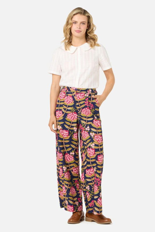 Image of a model wearing Pants. Productname: Protea Flower Relaxed Pant in Navy colour by brand - Princess Highway