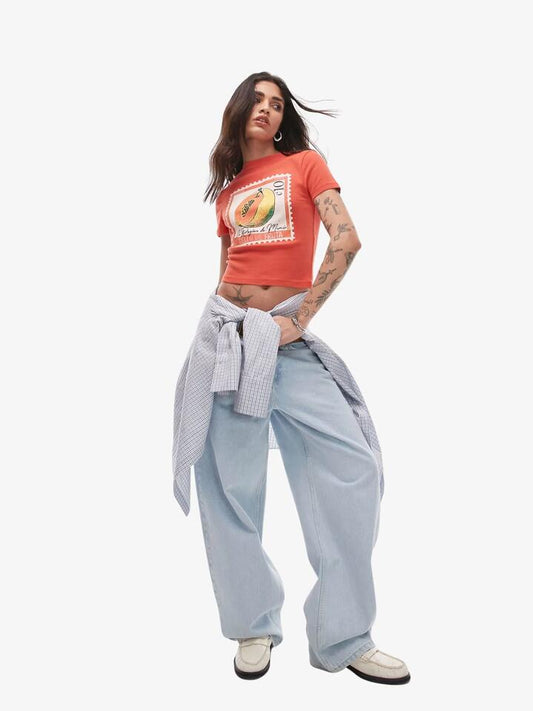 Image of a model wearing Tops. Productname: Topshop Graphic Papaya Baby Tee in Ecru colour by brand - Topshop