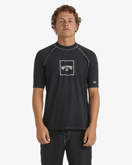 Image of a model wearing Tops. Product name - Billabong Mens Boxed Arch Short Sleeve Rash Vest Black in Black colour by brand - Billabong