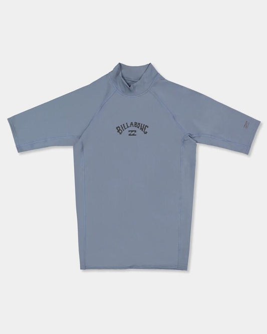 Image of a model wearing Tops. Product name - Billabong Mens All Day Arch Short Sleeve Rash Vest Steel Blue in Steel Blue colour by brand - Billabong
