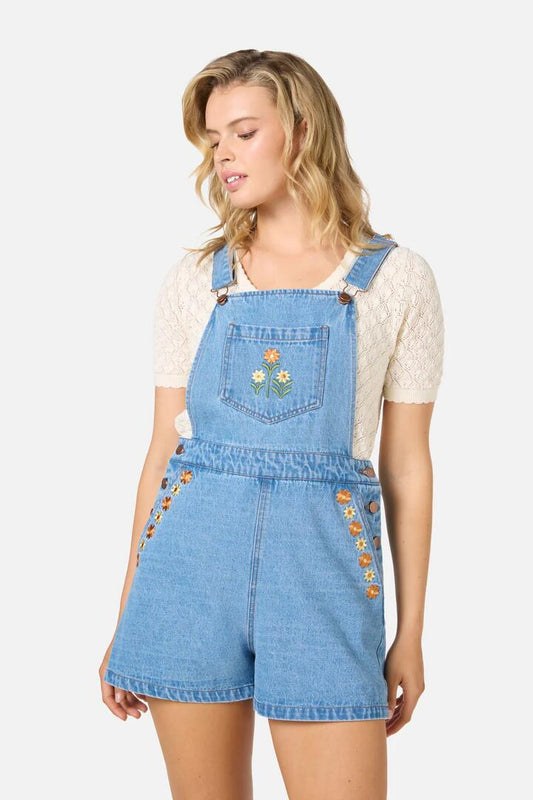Image of a model wearing Pants. Productname: Cleo Embroidered Short Overall in Blue Denim colour by brand - Princess Highway