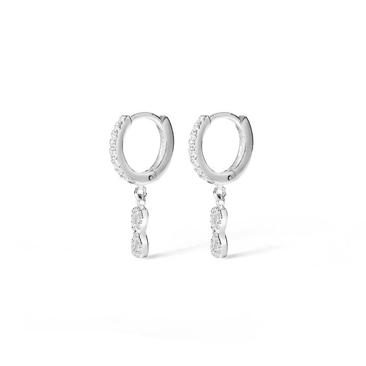 Image of Charms. Productname: Cubic Zirconia Infinity Charm Huggie Earrings in Sterling Silver in Silver colour by brand - Bevilles