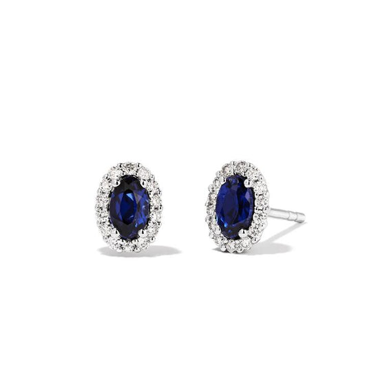 Image of Earrings. Productname: Oval Created Sapphire Halo Stud Earrings with 0.14tw of Laboratory-Grown Diamonds in Sterling Silver and Platinum in Diamond colour by brand - Bevilles