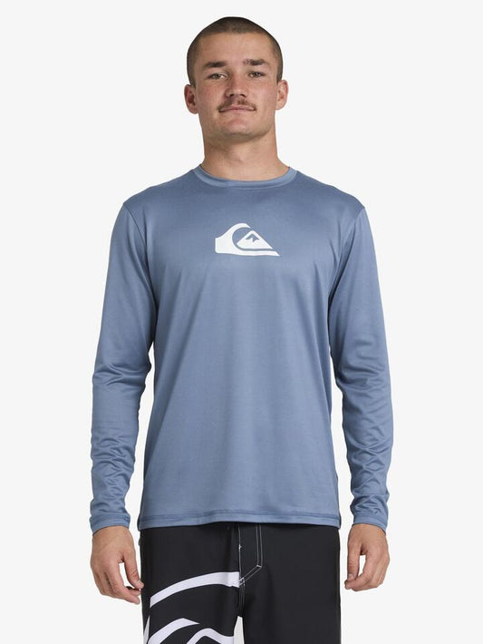 Image of a model wearing Tops. Productname: Quiksilver Mens Solid Streak Long Sleeve Surf Shirt China Blue - in China Blue colour by brand - Quiksilver