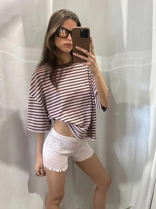 Image of a model wearing Shorts. Productname: Lioness Bloom Short Sleeve Tee in Chocolate Blush Stripe colour by brand - Lioness