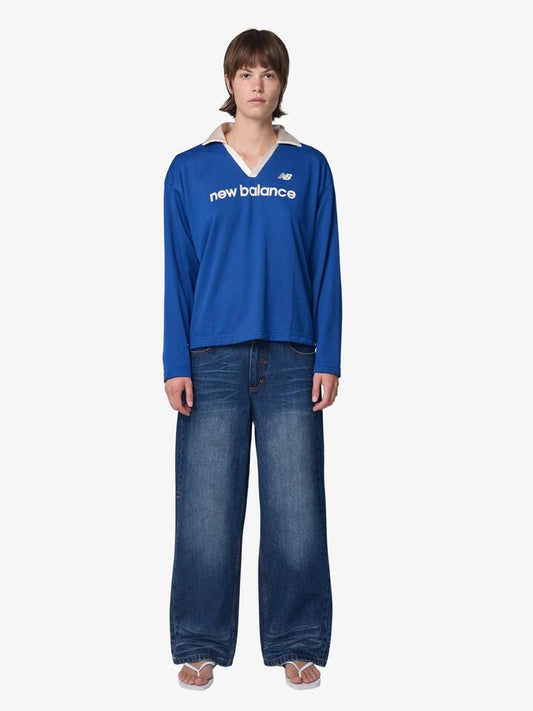 Image of a model wearing Tops. Productname: New Balance Mesh Jersey in Galaxy Blue colour by brand - New Balance