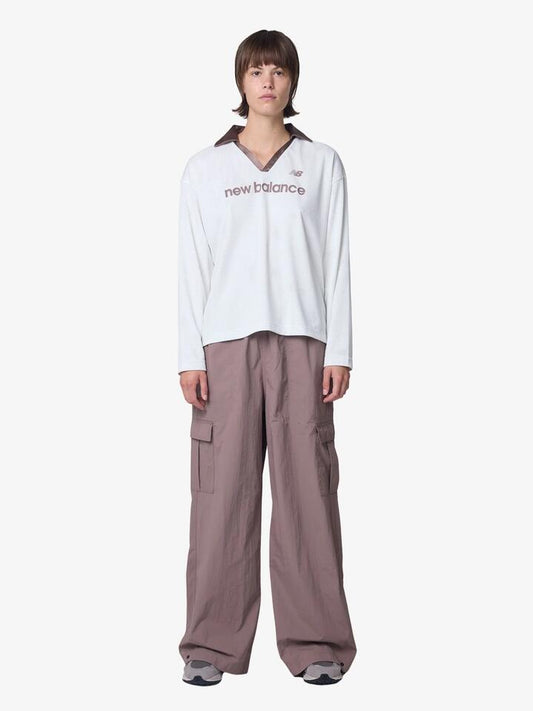 Image of a model wearing Tops. Productname: New Balance Mesh Jersey in Sea Salt colour by brand - New Balance