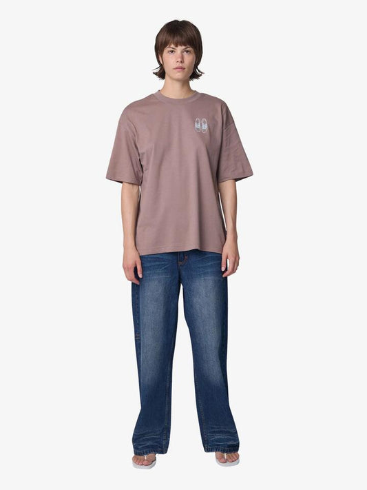 Image of a model wearing Tops. Productname: New Balance Outfit Layout T-Shirt in Earth Shadow colour by brand - New Balance