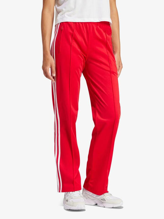 Image of a model wearing Pants. Productname: Adidas Women's Firebird Track Pants in Betsca colour by brand - Adidas