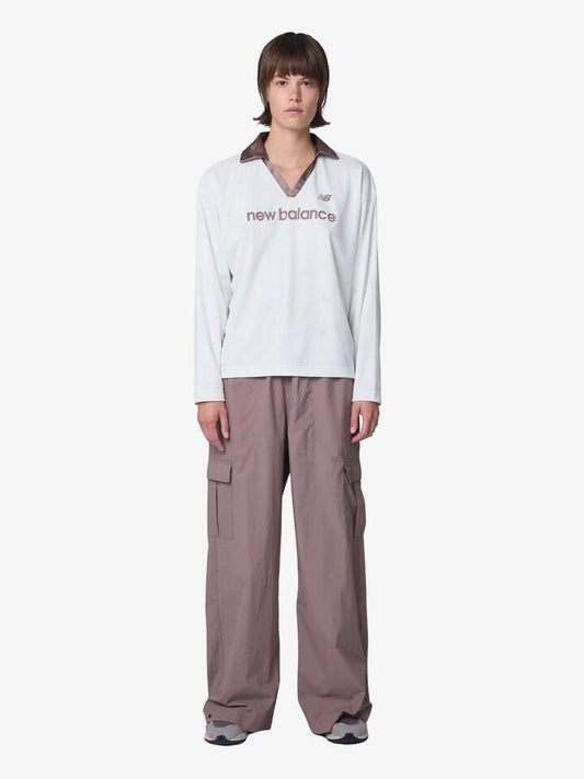 Image of a model wearing Pants. Productname: New Balance Woven Cargo Pants in Earth Shadow colour by brand - New Balance