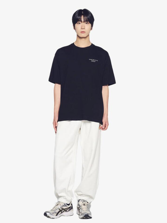 Image of a model wearing Tops. Productname: ADLV Ac Bear Basic Logo T-Shirt in Black colour by brand - ADLV