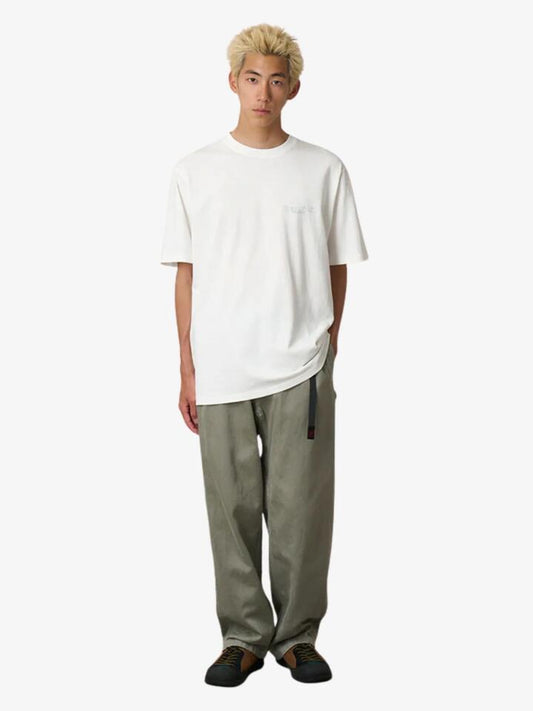 Image of a model wearing Tops. Productname: Gramicci Trouttail Tee in White colour by brand - Gramicci